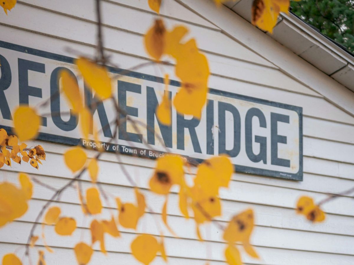 A building sign reading &ldquo;Property of Town of Breck&hellip;&rdquo; framed by autumn yellow leaves.
